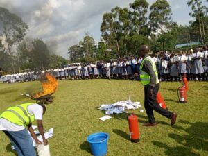 Lindum Systems team conducting certified fire safety training in Kenya with live extinguisher demo during a safety drill