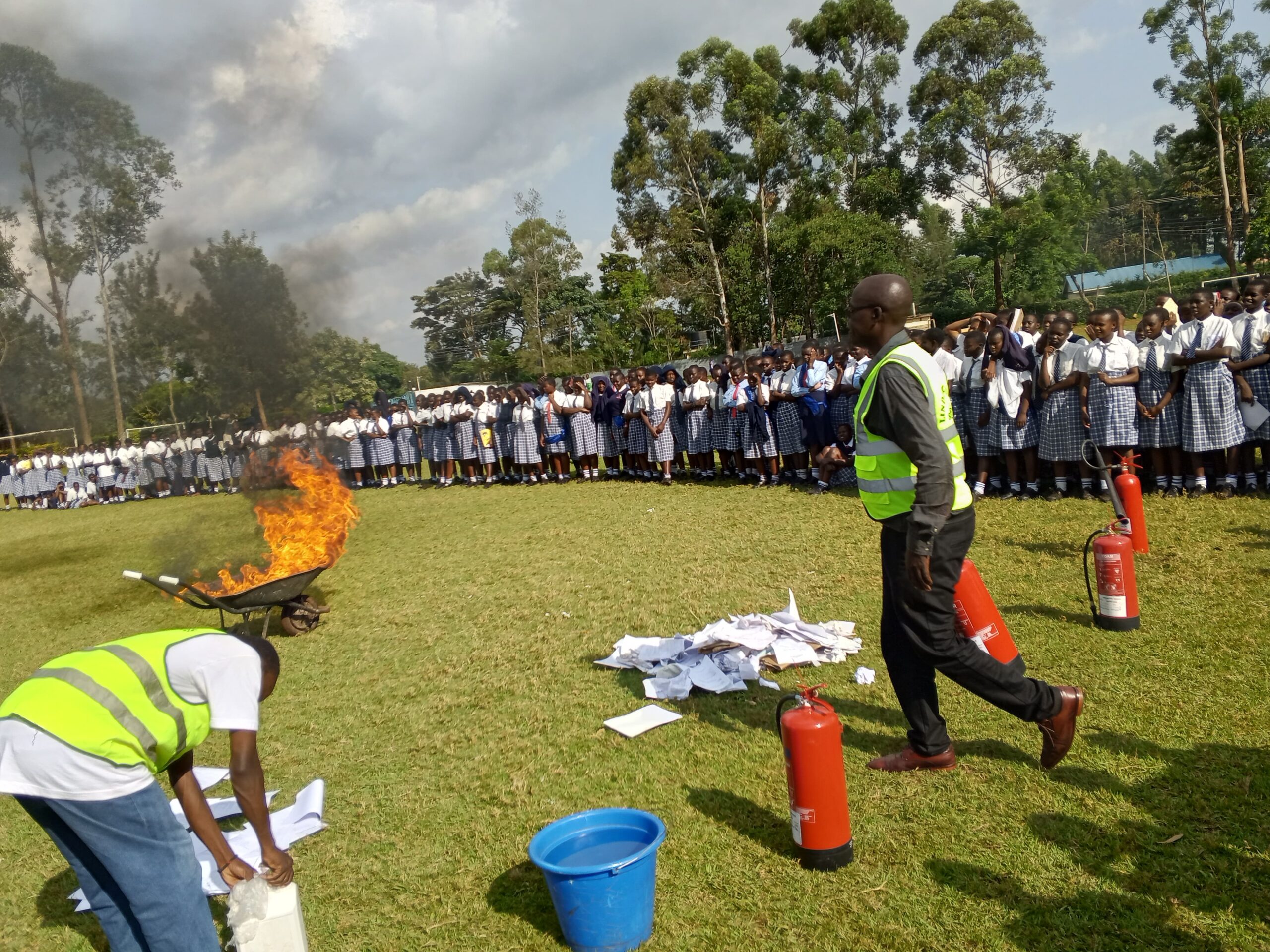 Lindum Systems team conducting certified fire safety training in Kenya with live extinguisher demo during a safety drill
